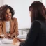 A female hotel manager interviews a woman for a hotel job.